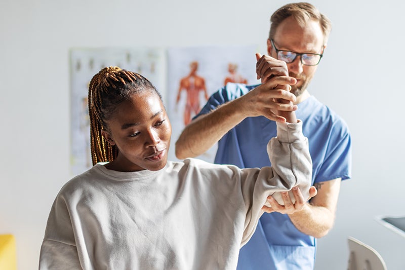 Patient being examined by doctor for shoulder pain