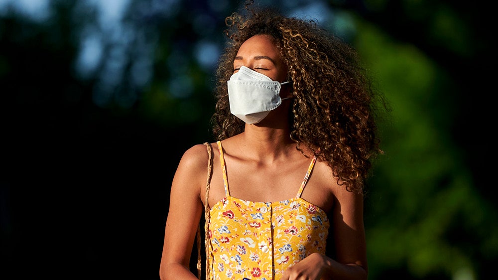 young black woman outside wearing mask