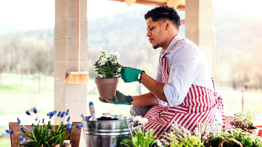 man working on his potted garden plants