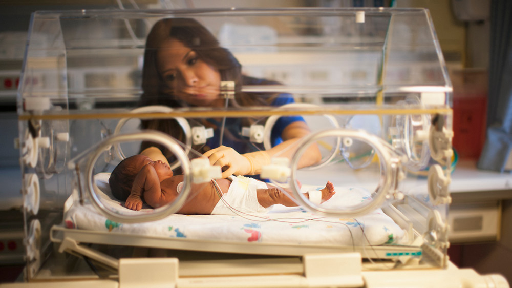 baby in NICU holder