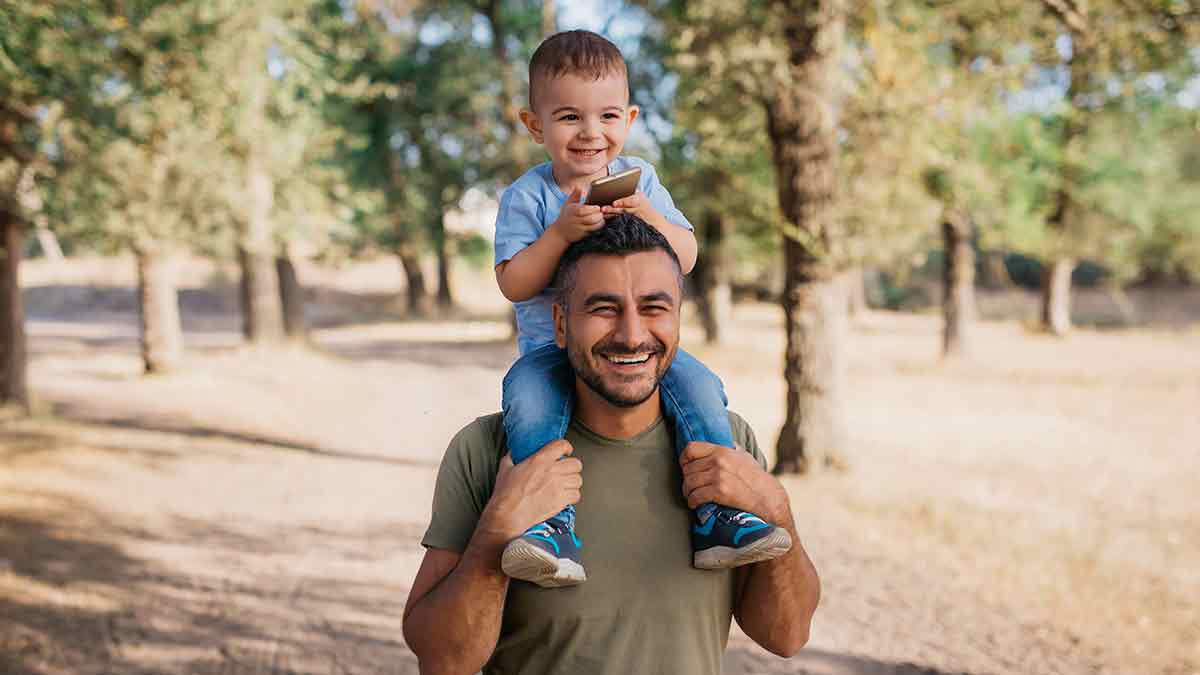 man with child on shoulders