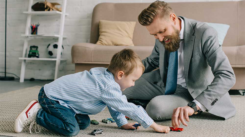 father playing with son after work