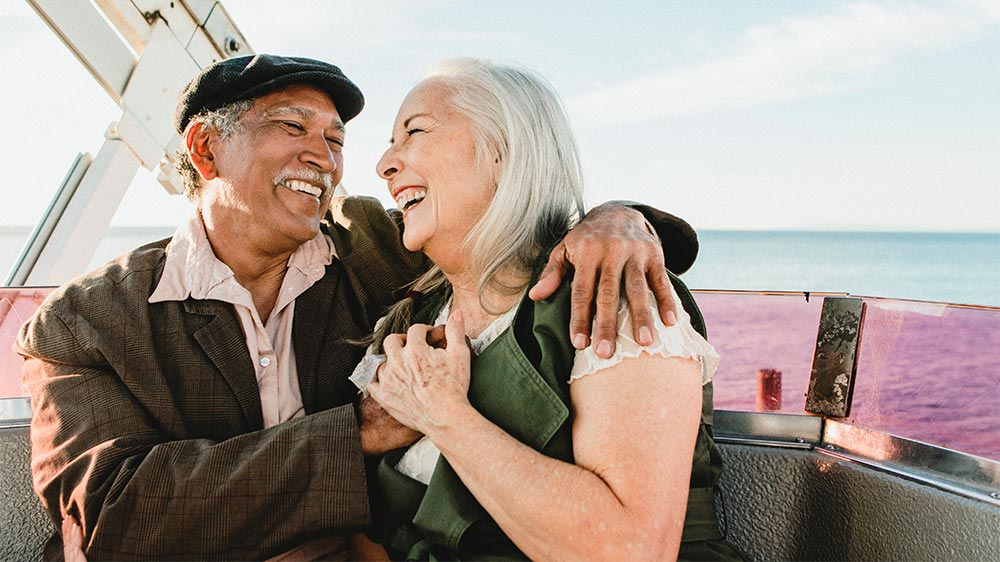 older couple on Ferris wheel over water