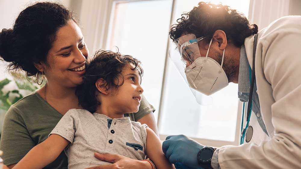 doctor with mask talking to child