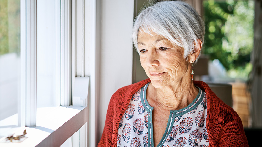 older woman standing near window