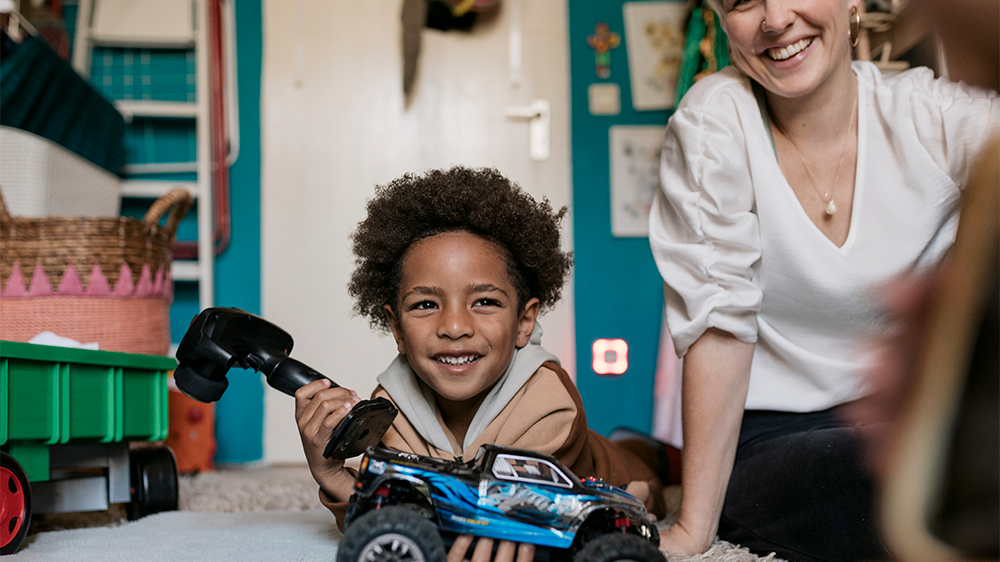 child playing with motorized toy car