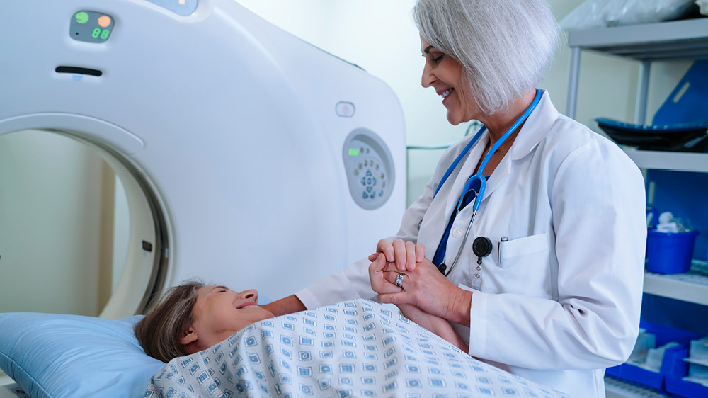 Caucasian doctor comforting patient near scanner