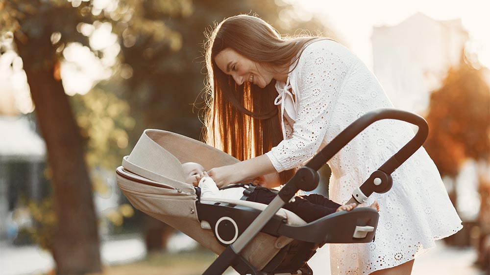 mother walking baby in stroller