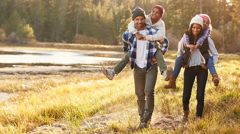 parents giving children piggyback rides