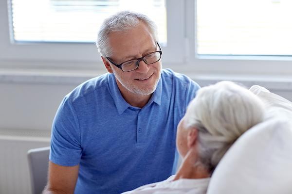 man looking at woman in bed