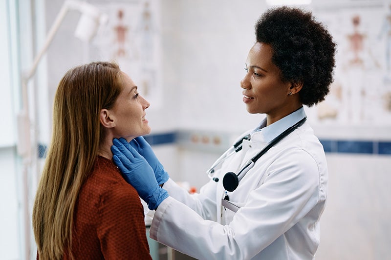 Doctor examining a women's neck